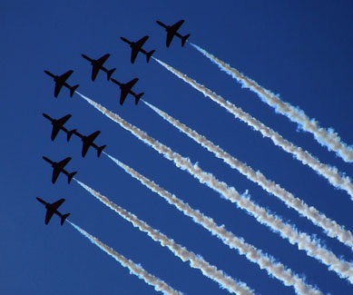 A precision aerobatic team flies in formation at the Farnborough Air Show