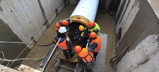 Contractors lay pipe to make improvements to community infrastructure
