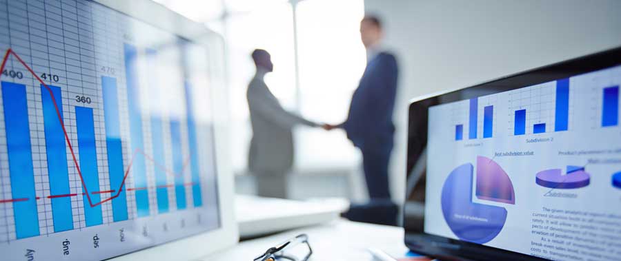 Economic development professionals shake on an agreement during a meeting