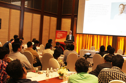 Attendees watch a presentation on information technology in India