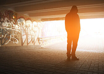 Silhouette of youth under bridge