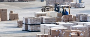 Pallets of shrink wrapped products await loading on a cargo ship