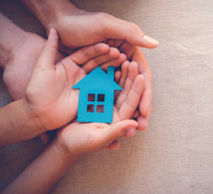 Young hands holding dream of affordable home