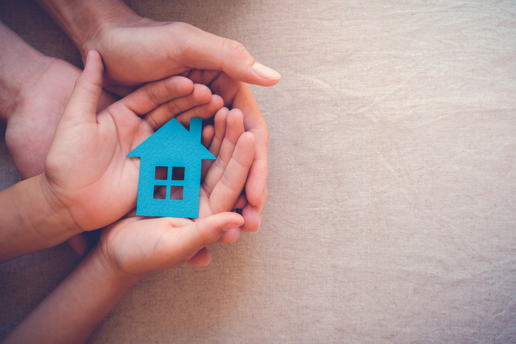 Image of a small home in a family's hands