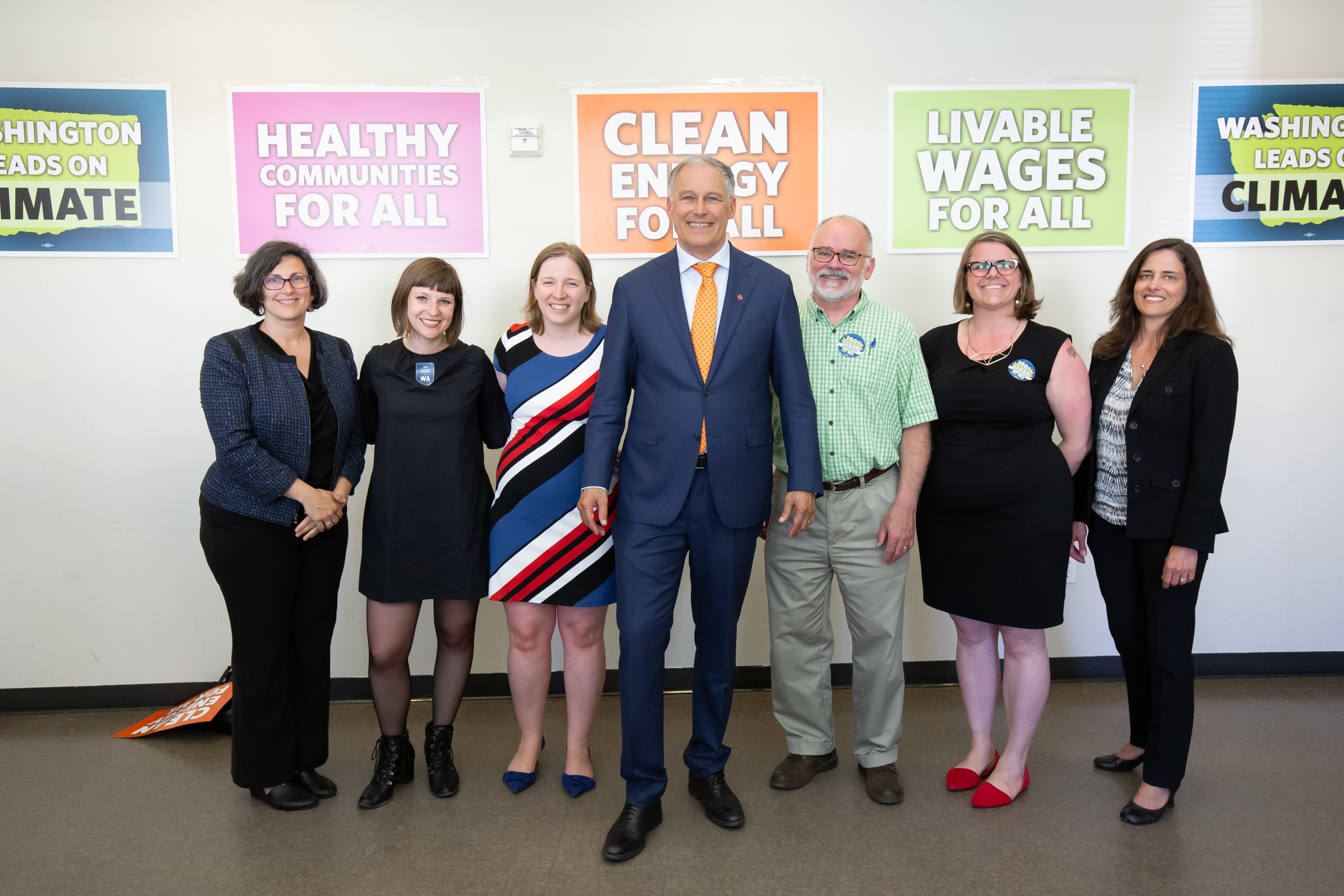 Gov. Inslee poses with Commerce staff at signing event