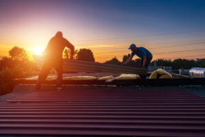 Men installing solar panels on the top of a roof.