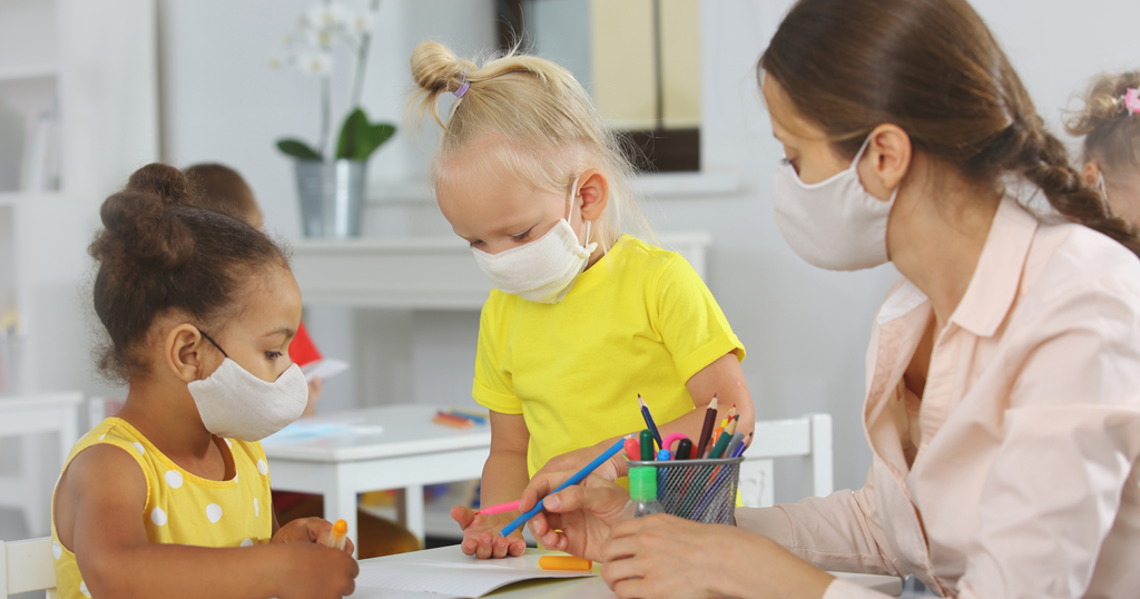 Children at child care facility learning from instructor.