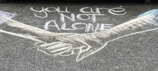 Chalk illustration saying "you are not alone"