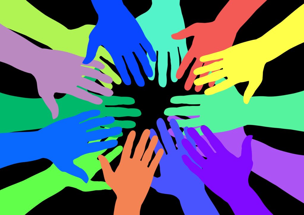 colorful hands in a team circle