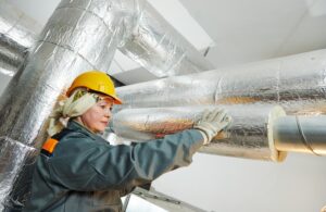 Phot of a woman working on an HVAC system