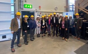 Photo of Nordic delegation members in hardhats at MARO assembly hall