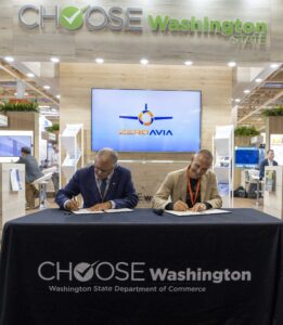Photo of Governor Inslee and ZeroAvia CEO and Found Val Miftakhov signing agreement at a a press conference in Paris