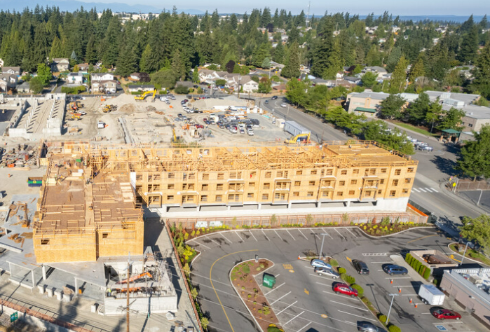 Photo of construction site with an apartment complex structure.
