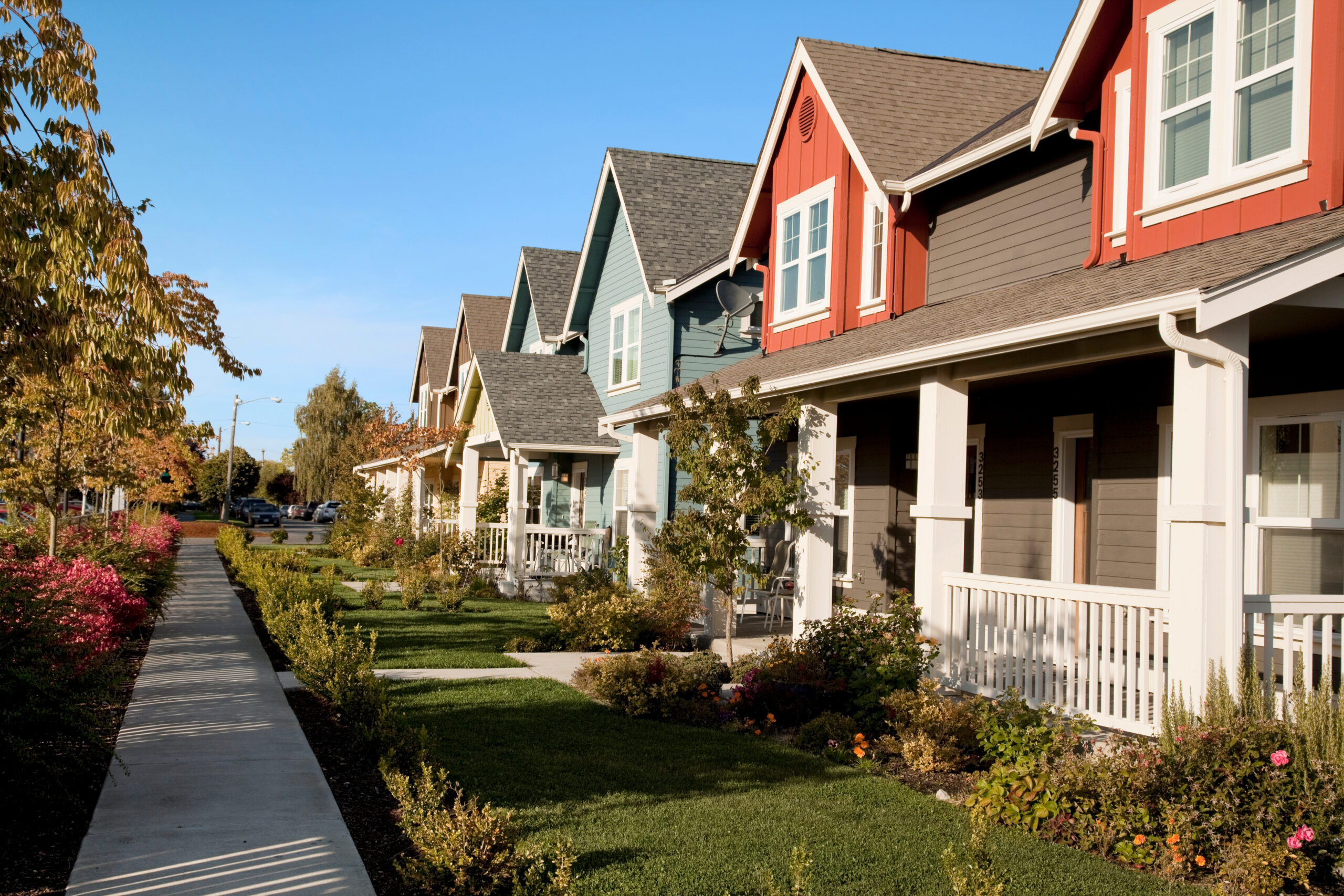 Photo of row of duplex housing in a neighborhood.
