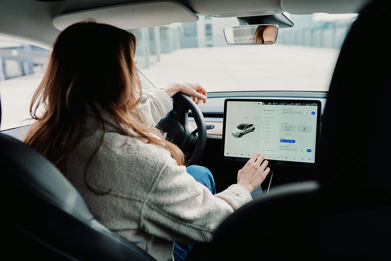 An EV driver uses the control panel to adjust settings.