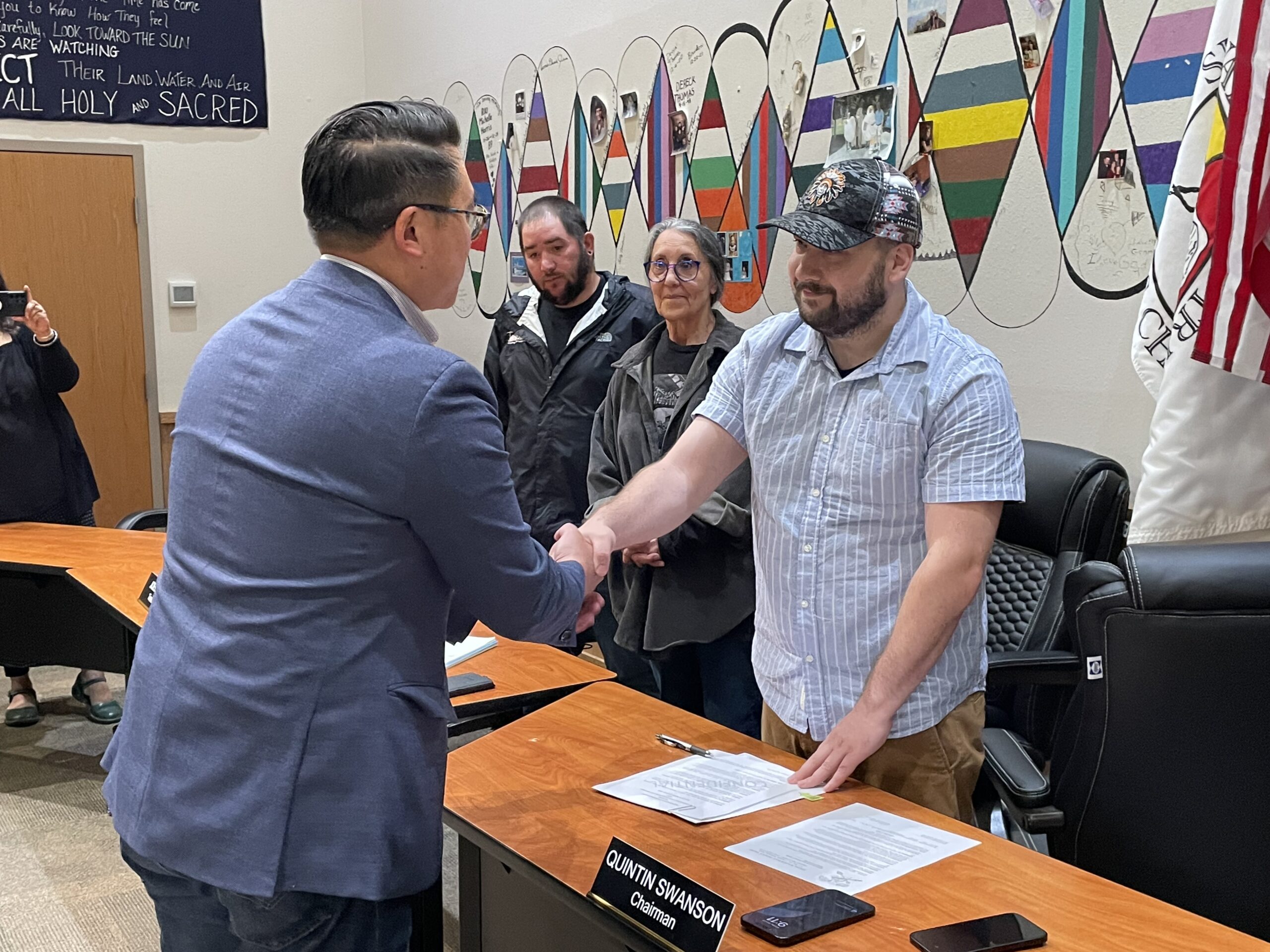 Shoalwater Bay Tribal Chairman Quintin Swanson and Director Joe Nguyen shake hands after signing the MOU as Shoalwater Bay Tribal Council Secretary Lynn Clark and Shoalwater Bay Tribal Council Treasurer Joel Blake look on.