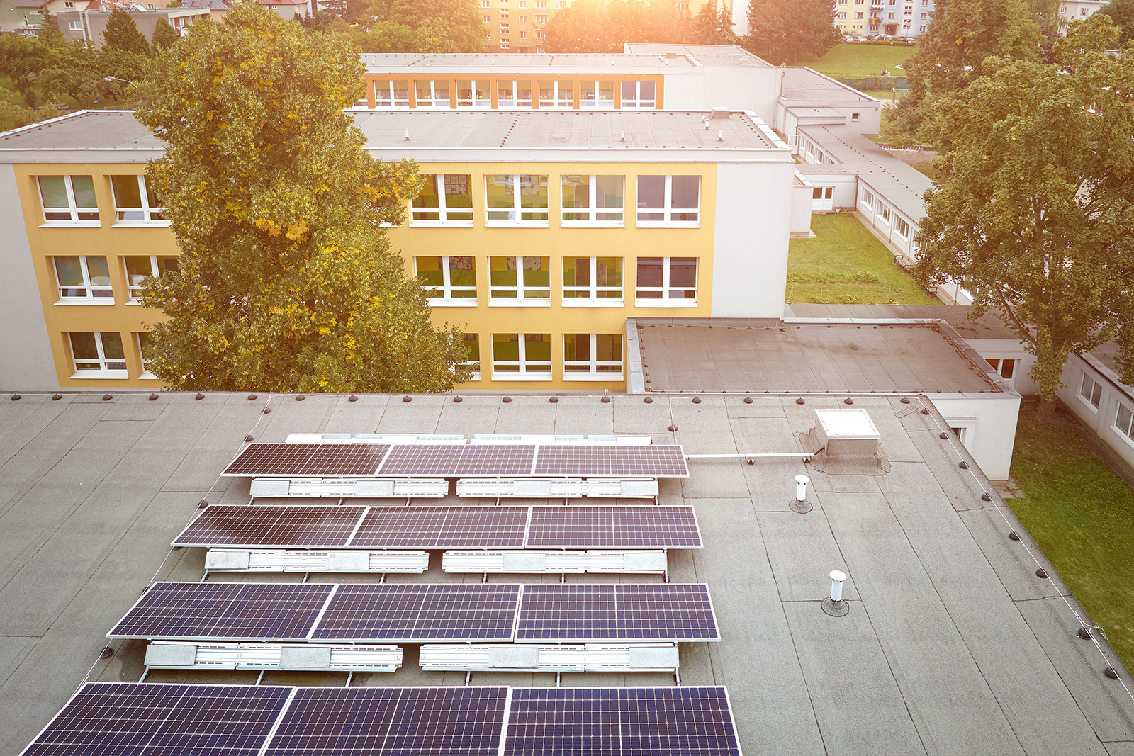 Solar panels on a school. Adobe Stock.